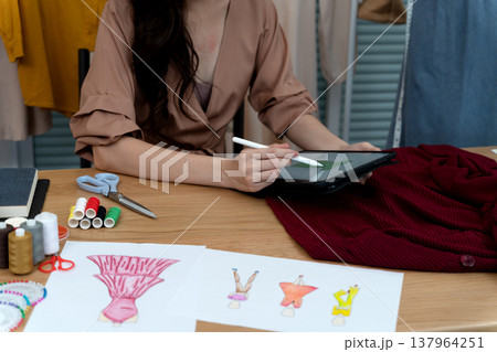 young woman designer drawing clothes design 137964251