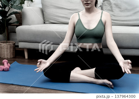 young woman doing her own yoga sit relax poses at home on the sofa young woman doing her own yoga sit relax poses at home on the sofa 137964300