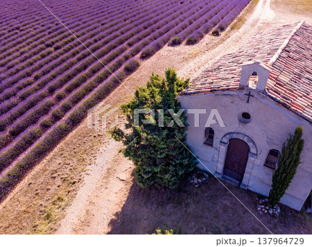 Lavender field and chapel at Entrevennes village, France. Aerial view Lavender field and chapel at Entrevennes village, France. Aerial view 137964729