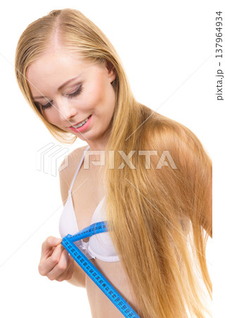 Woman measuring her chest breasts bust size 137964934