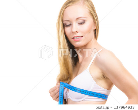 Girl measuring her chest breasts bust size Girl measuring her chest breasts bust size 137964935