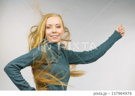 Smiling woman with blowing long hair 137964978