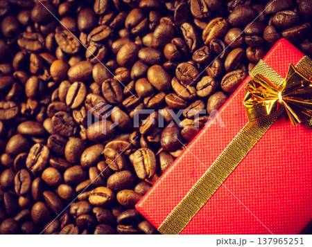 Red gift box on roasted coffee beans. Red gift box on roasted coffee beans. 137965251