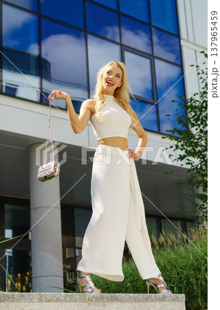 Cheerful fashionable woman in city Cheerful fashionable woman in city 137965459