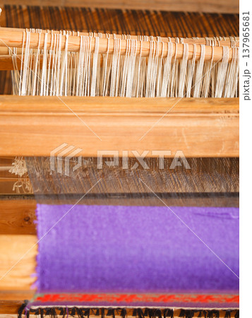 Oldfashioned thread on old spindle, spinning wheel Oldfashioned thread on old spindle, spinning wheel 137965681