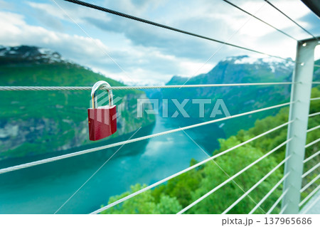 Red padlock and Geirangerfjord from Flydasjuvet viewpoint Norway Red padlock and Geirangerfjord from Flydasjuvet viewpoint Norway 137965686