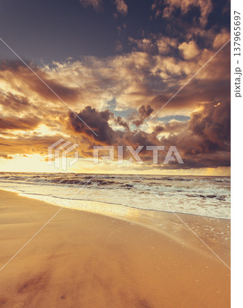 Beatiful sunset with clouds over sea and beach Beatiful sunset with clouds over sea and beach 137965697