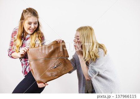 Two women being excited about brown skirt Two women being excited about brown skirt 137966115
