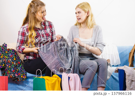 Two unhappy female friends after shopping 137966116