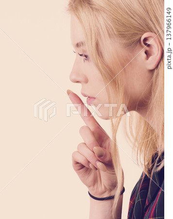 Woman showing silence gesture Woman showing silence gesture 137966149