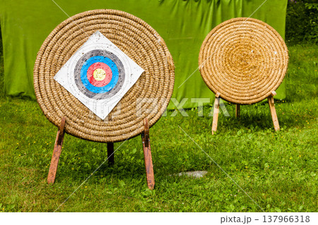 Shooting target and bullseye with many bullet holes 137966318