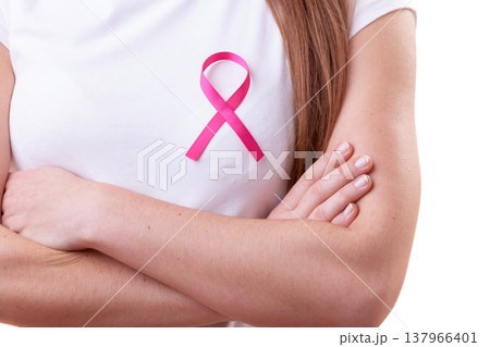 Pink ribbon on woman chest to support breast cancer cause Pink ribbon on woman chest to support breast cancer cause 137966401