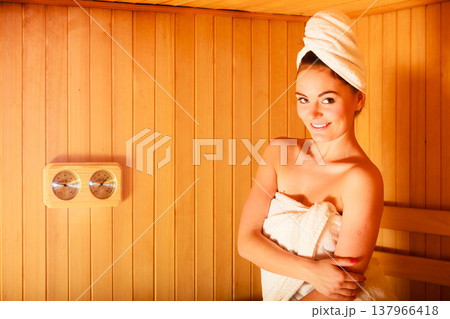 woman relaxing in wooden sauna room 137966418