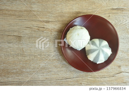 Chinese steamed bun stuffed sweet mashed red bean and salty chop pork on plate 137966834