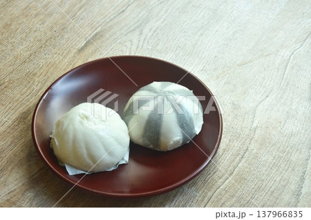 Chinese steamed bun stuffed sweet mashed red bean and salty chop pork on plate Chinese steamed bun stuffed sweet mashed red bean and salty chop pork on plate 137966835