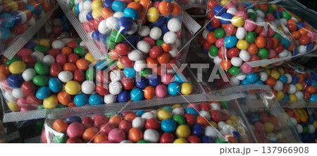 Colorful Candy-Coated Chocolates in Plastic Packaging Colorful Candy-Coated Chocolates in Plastic Packaging 137966908