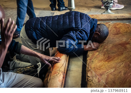 Christian pilgrims on the Stone of Anointing, Holy Sepulchre in Jerusalem. Christian pilgrims on the Stone of Anointing, Holy Sepulchre in Jerusalem. 137968911