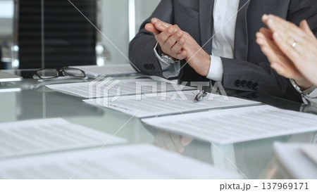Business people applauding during a meeting, celebrating a successful deal, contract signing, or new partnership agreement. Businesspeople concept Business people applauding during a meeting, celebrating a successful deal, contract signing, or new partnership agreement. Businesspeople concept 137969171