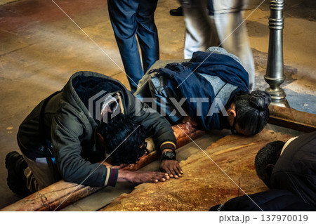 Christian pilgrims on the Stone of Anointing, Holy Sepulchre in Jerusalem. 137970019