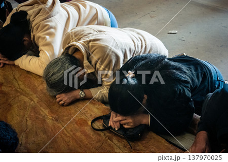 Christian pilgrims on the Stone of Anointing, Holy Sepulchre in Jerusalem. Christian pilgrims on the Stone of Anointing, Holy Sepulchre in Jerusalem. 137970025