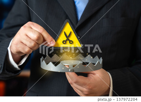 A trap and symbol of cuts and layoffs. A spiral of falling profits and workforce reduction. Economic downturn forces budget cuts and restructuring as companies struggle to maintain stability A trap and symbol of cuts and layoffs. A spiral of falling profits and workforce reduction. Economic downturn forces budget cuts and restructuring as companies struggle to maintain stability 137972204