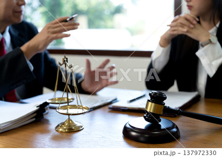 Lawyers talking to a team of women in Law firm Lawyers talking to a team of women in Law firm 137972330
