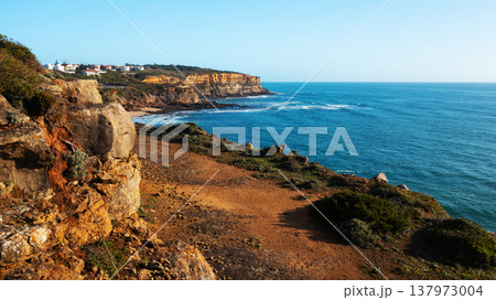 Beautiful natural landscape with ocean rocky shore with blue sky. Scenic ocean landscape on summer sunny day. Beautiful rocky coast at Santu Isidoro. Portugal. Europe. Beautiful natural landscape with ocean rocky shore with blue sky. Scenic ocean landscape on summer sunny day. Beautiful rocky coast at Santu Isidoro. Portugal. Europe. 137973004