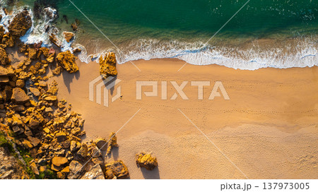 Beautiful landscape with sandy beach and big stones. Beautiful ocean beach with yellow sand, aerial view. Drone view of blue waves and sandy beach with stones. Portugal. Top view. Drone photography Beautiful landscape with sandy beach and big stones. Beautiful ocean beach with yellow sand, aerial view. Drone view of blue waves and sandy beach with stones. Portugal. Top view. Drone photography 137973005