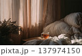 Cozy Minimalist Bedroom with Morning Tea Cup and Golden Hour Light 137974150