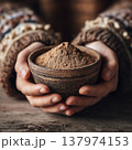 Close-up Hands Cupping Handmade Bowl with Organic Spice or Herb Powder 137974153
