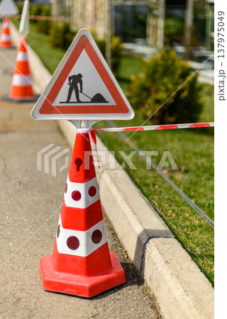 Roadwork cone with warning sign Roadwork cone with warning sign 137975049