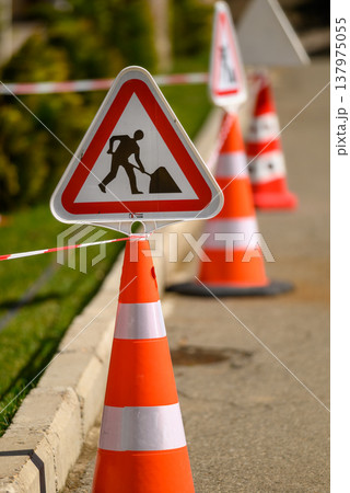 Roadworks warning sign with orange traffic cones Roadworks warning sign with orange traffic cones 137975055