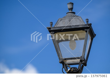 Vintage street lantern against blue sky 137975061
