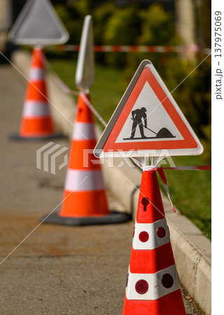 Roadworks warning sign on traffic cones 137975069
