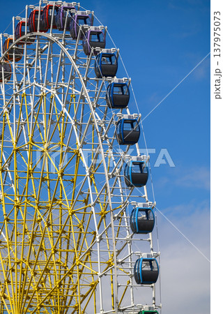 Ferris wheel detail with gondola cabins on blue sky Ferris wheel detail with gondola cabins on blue sky 137975073