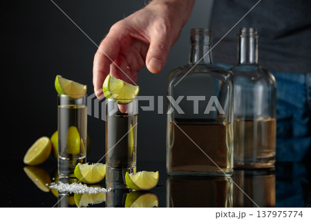 Gold tequila with sea salt and lime slices. 137975774
