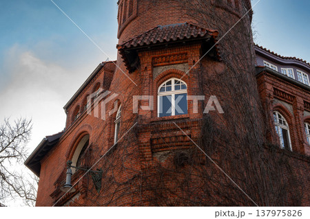Historic Red Brick Tower with Ivy Covered Facade 137975826