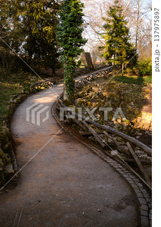 Curving Park Path with Rustic Fence and Small Dog 137975897