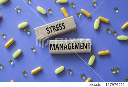 STRESS MANAGEMENT symbol. Concept word STRESS MANAGEMENT on wooden blocks. Beautiful purple background with pills. Medicine and STRESS MANAGEMENT. Copy space STRESS MANAGEMENT symbol. Concept word STRESS MANAGEMENT on wooden blocks. Beautiful purple background with pills. Medicine and STRESS MANAGEMENT. Copy space 137976951