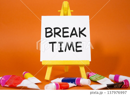 Break Time symbol. Concept word Break Time on wooden blocks. Beautiful orange background with paints and easel. Business and Break Time concept. Copy space Break Time symbol. Concept word Break Time on wooden blocks. Beautiful orange background with paints and easel. Business and Break Time concept. Copy space 137976997
