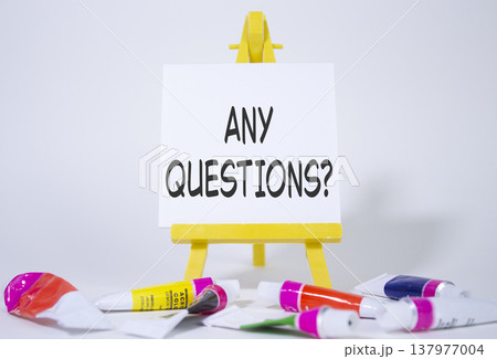 Any Questions symbol. Wooden blocks with words Any Questions . Beautiful white background with paints and easel. Business and Any Questions concept. Copy space. 137977004