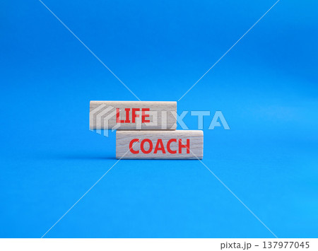 Life Coach symbol. Concept word Life Coach on wooden blocks. Beautiful blue background. Business and Life Coach concept. Copy space 137977045