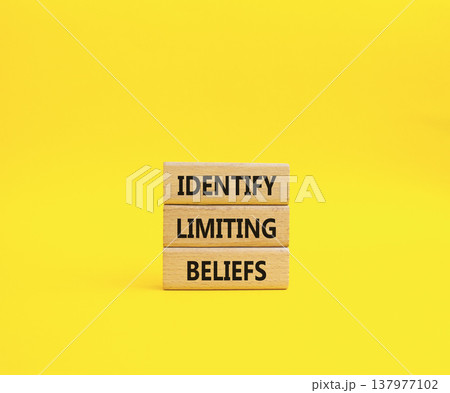Limiting Beliefs symbol. Concept word Identify Limiting Beliefs on wooden blocks. Beautiful yellow background. Business and Limiting Beliefs concept. Copy space 137977102