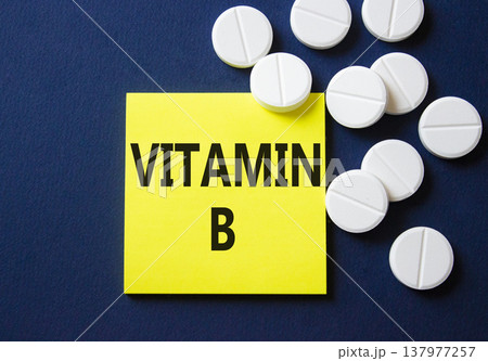 Vitamin B symbol. Concept word Vitamin B on yellow note. Beautiful deep blue background with pills. Medicine and Vitamin B concept. Copy space 137977257