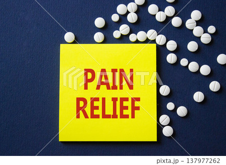 Pain Relief symbol. Concept word Pain Relief on yellow note. Beautiful deep blue background with pills. Medicine and Pain Relief concept. Copy space Pain Relief symbol. Concept word Pain Relief on yellow note. Beautiful deep blue background with pills. Medicine and Pain Relief concept. Copy space 137977262