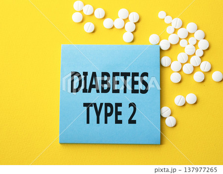 Diabetes Type 2 symbol. Concept word Diabetes Type 2 on blue note. Beautiful yellow background with pills. Medicine and Diabetes Type 2 concept. Copy space 137977265