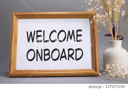 Welcome onboard symbol. Concept words Welcome onboard on beautiful wooden picture frame. Beautiful grey background with flower vase. Business and Welcome onboard concept. Copy space. 137977284