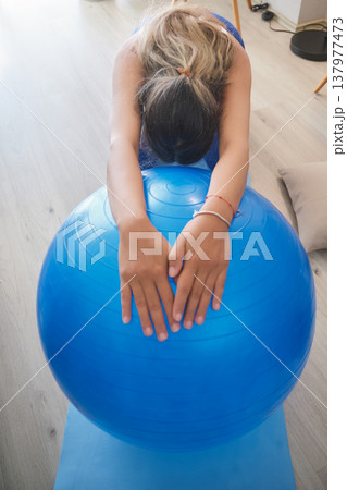 Pregnant woman exercising with fitness ball at home Pregnant woman exercising with fitness ball at home 137977473