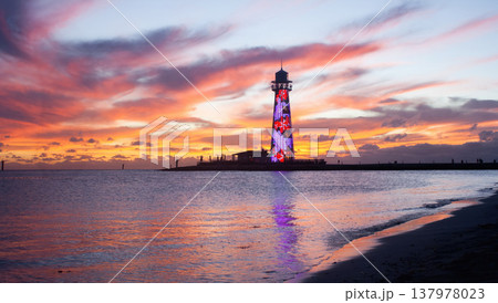 Bahamas summer sunset with lighthouse illuminated with flowers in the background. Tropical beach. Wallpaper Bahamas summer sunset with lighthouse illuminated with flowers in the background. Tropical beach. Wallpaper 137978023