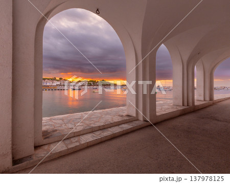 Harbor view through white arches at sunrise in Cadaques, Catalonia, Spain Harbor view through white arches at sunrise in Cadaques, Catalonia, Spain 137978125